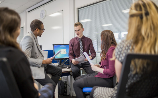 Students and lectures working together in a lab