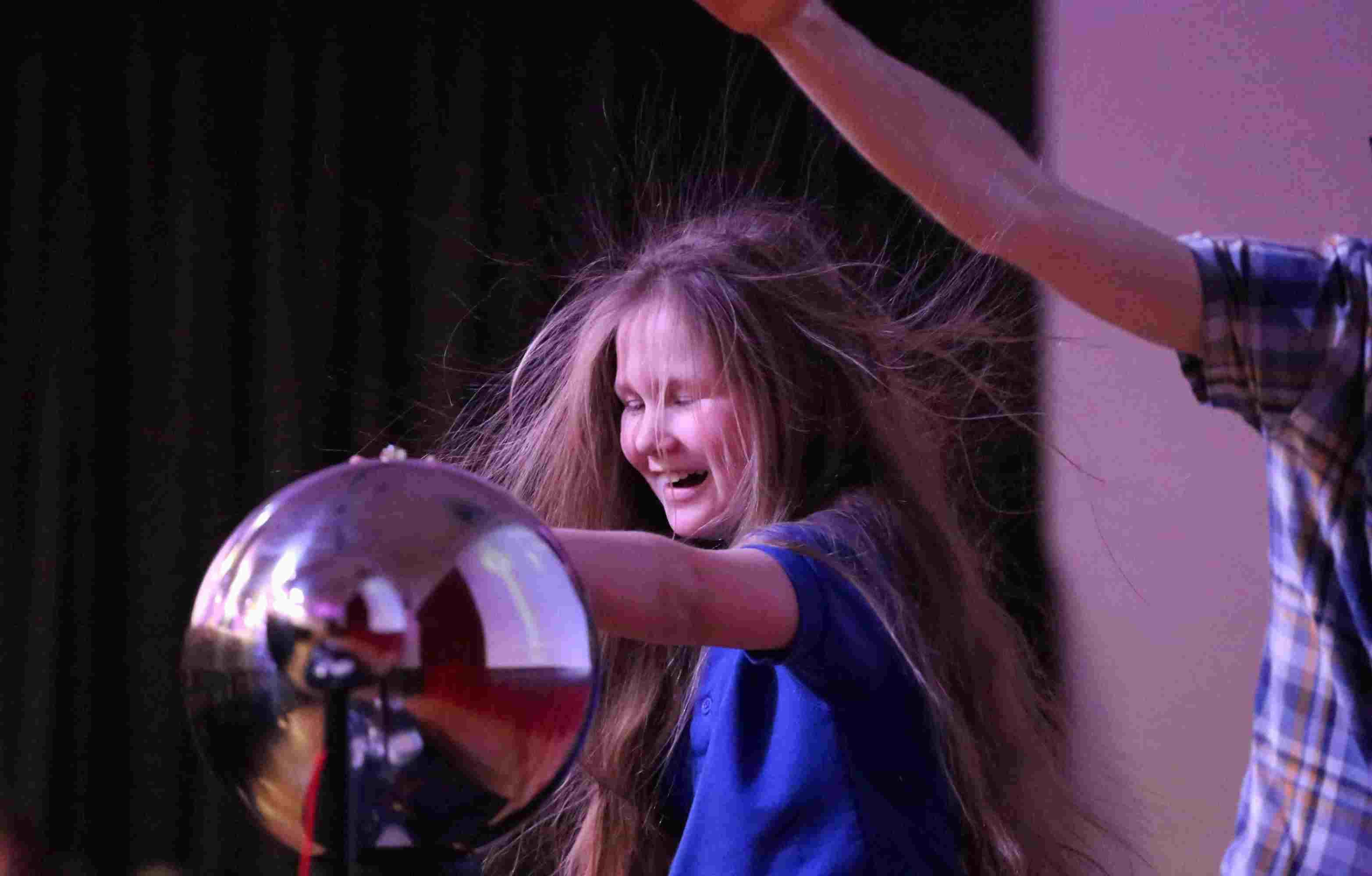 a girl touching a glass ball