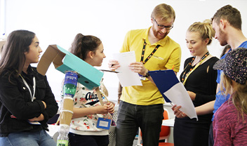 Luke Clements and Casey Hopkins talk with staff at a technocamps event