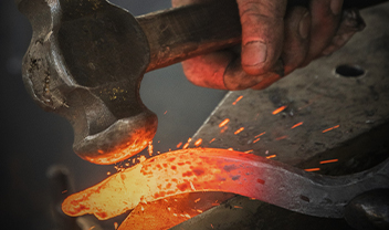 A hammer striking hot iron