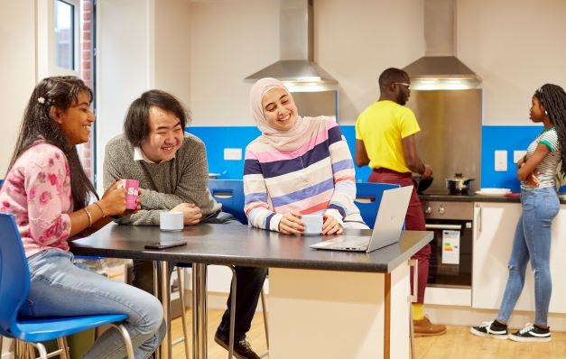 Students in their shared kitchen at Rod Jones Hall