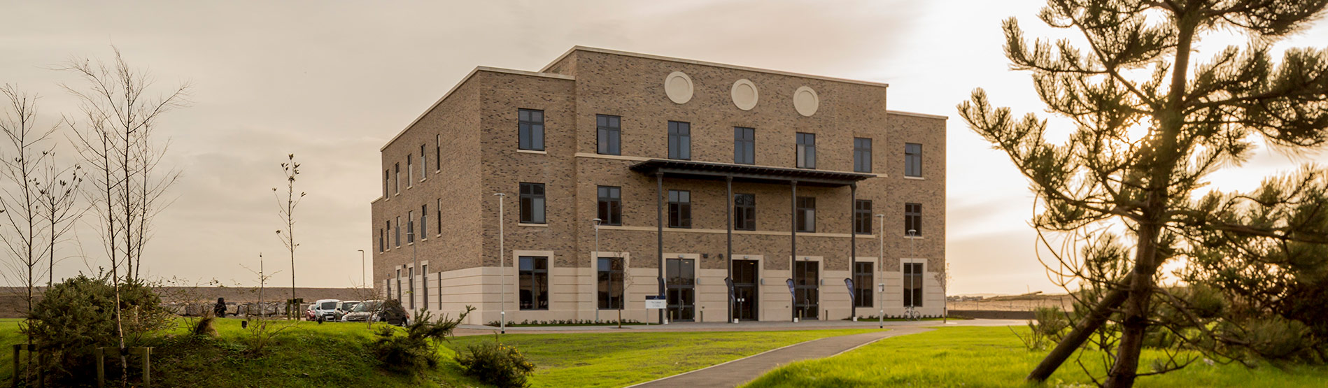 Photo from a distance of the new academic building for The College, Swansea University.