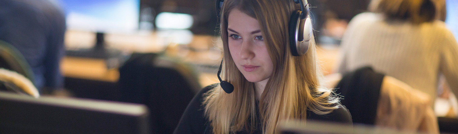 Student working while wearing a headset.