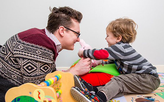 Student interacting in study with a young child.