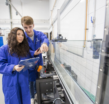 Students in Fluid lab with blue lab coats