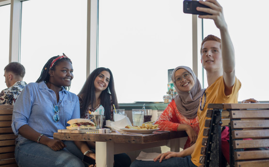 Students taking a selfie in a mumbles cafe