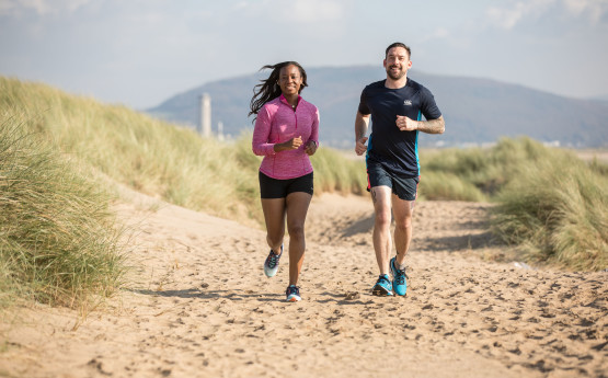 Students running on beach