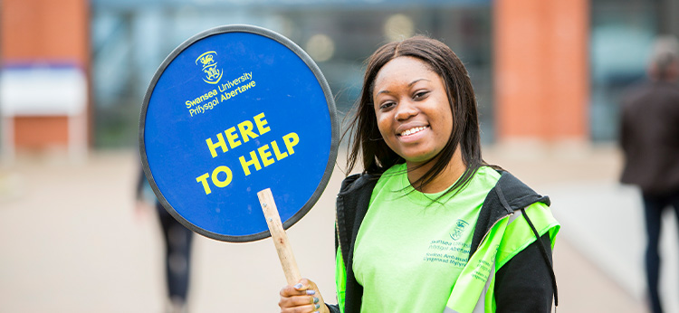 Student with here to Help sign