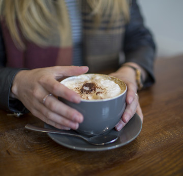 Female holding a coffee cup